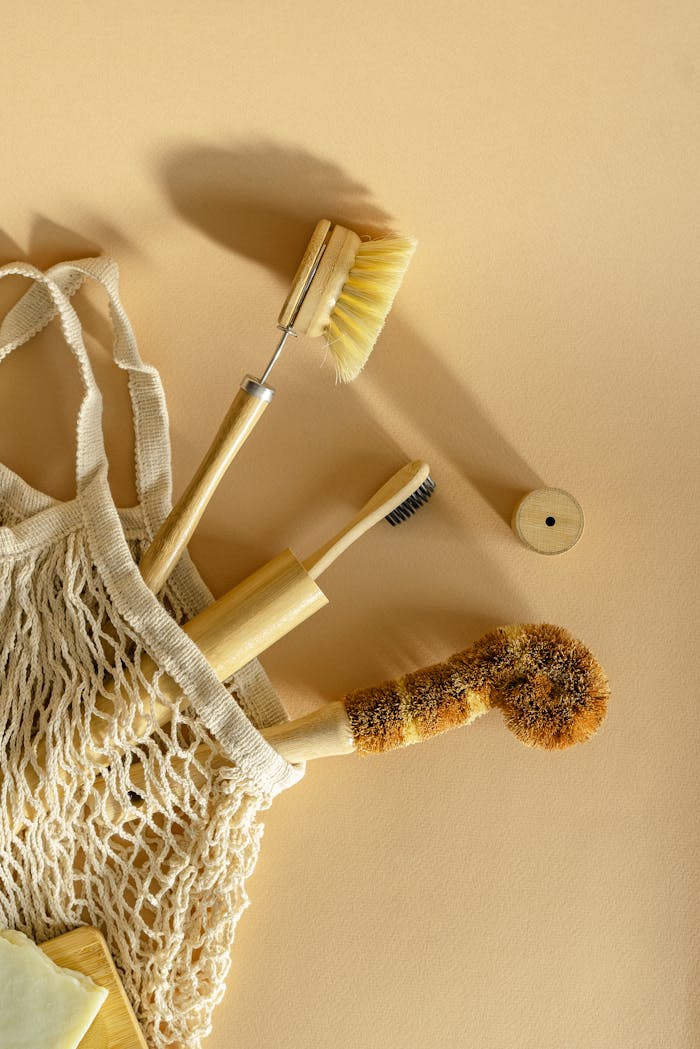 Minimalist shot of eco-friendly brushes and net bag on beige background.