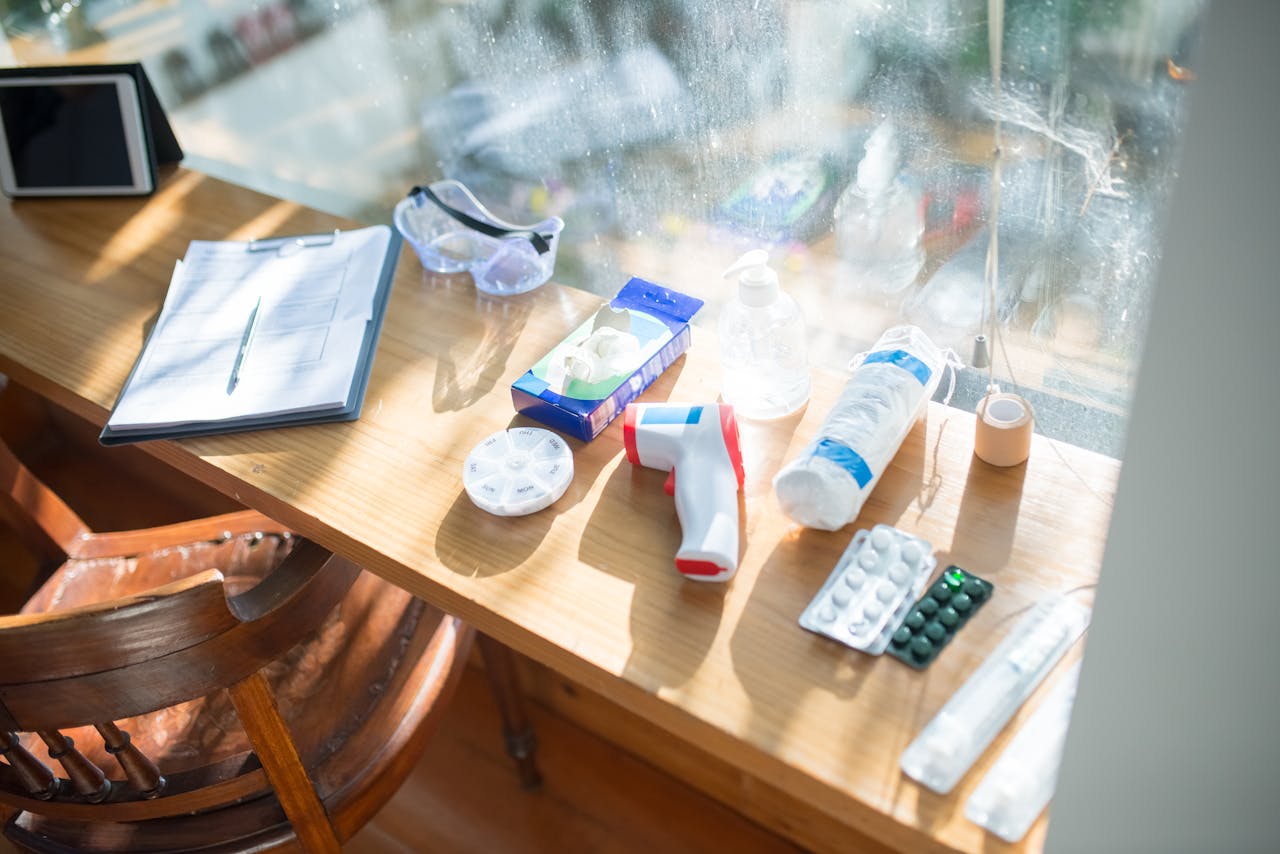 A sunlit desk with medical supplies and a clipboard, perfect for home healthcare concepts.